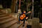 Man strumming guitar on stairwell to Michelangelo's Square.