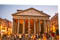 Pantheon at sunset surrounded by tourists.